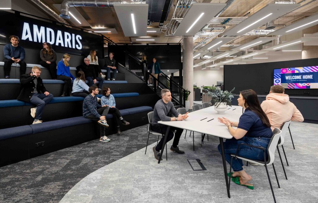 Amdaris team members working in the company's office space