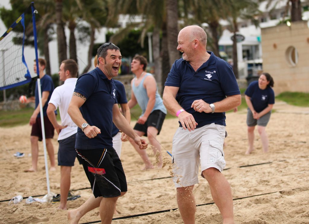 Brian McConnell playing volleyball with Hydrock team members