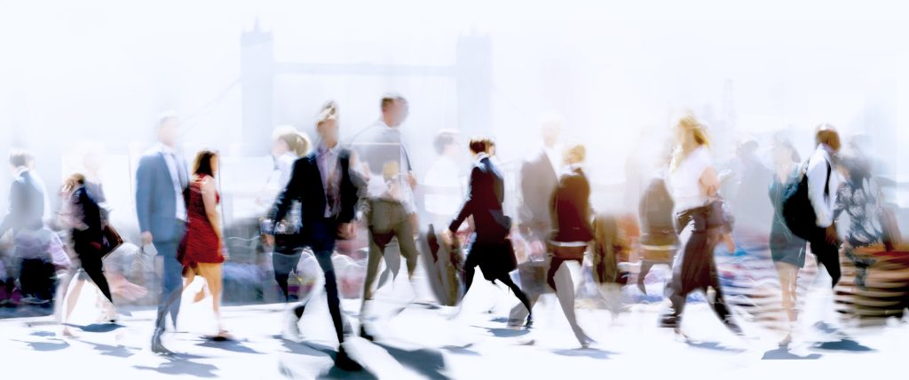 Blurred graphic of business people walking around the city in front of the Tower of London