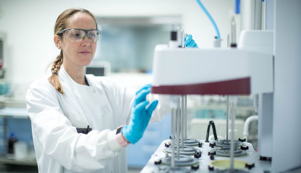 Arcinova team member operating a machine in their lab