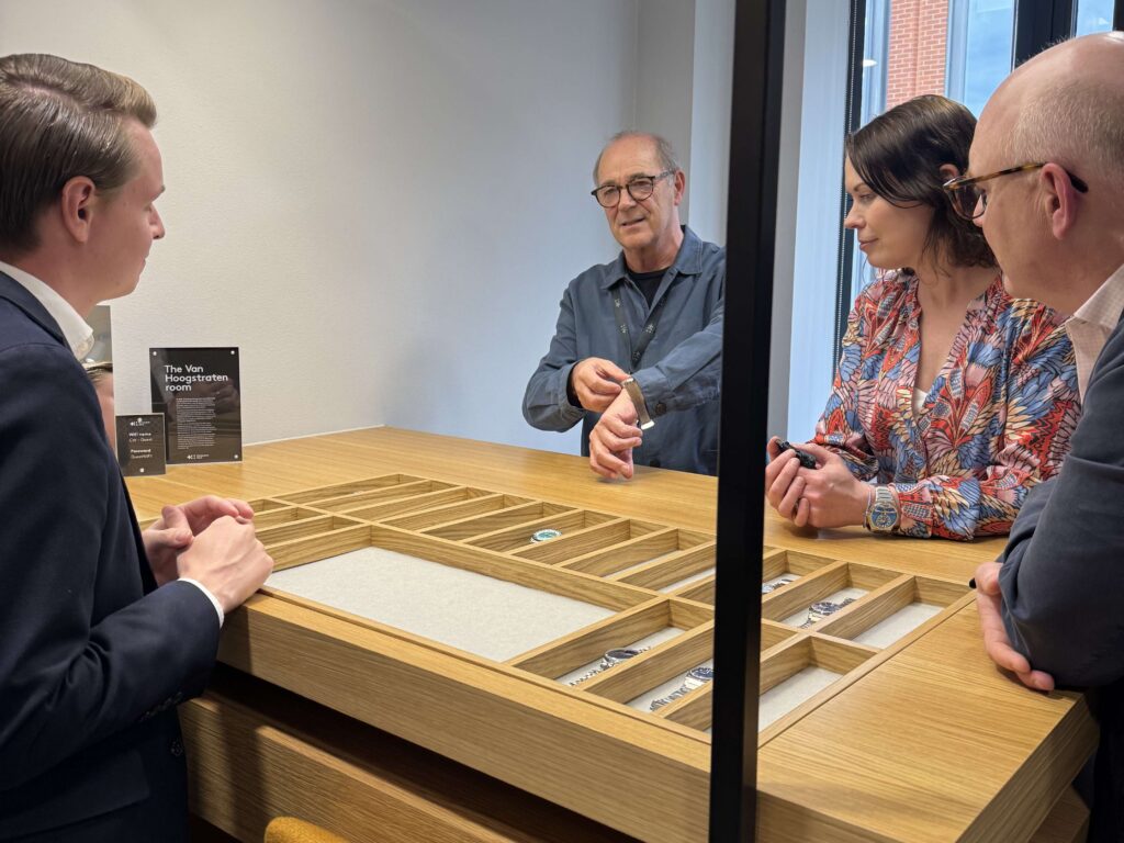 Group looking at watches during MP visit to Christopher Ward
